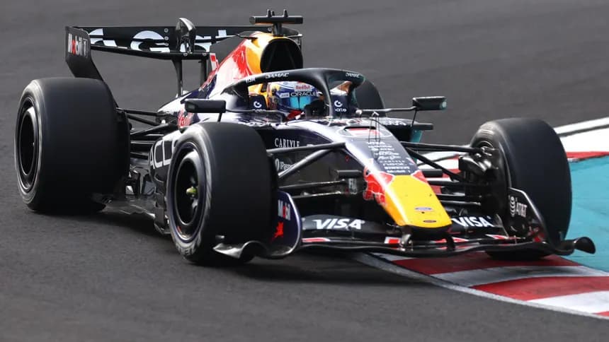 Red Bull Racing pit crew readying the Formula 1 car during an intense race event.